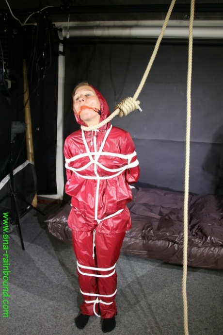 A restrained girl, Sandra wears a ball and tie herself up with her hair tied back in the sunniest raincoat.