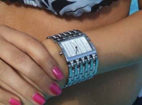 Roxy, an amusement park enthusiast in a swimming pool, looks at her Morgan watch.