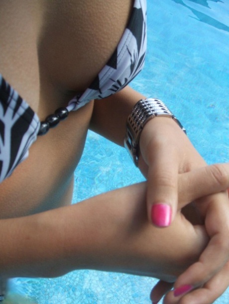 Roxy, an amateur chick, takes a glance at her Morgan watch while swimming in a pool.