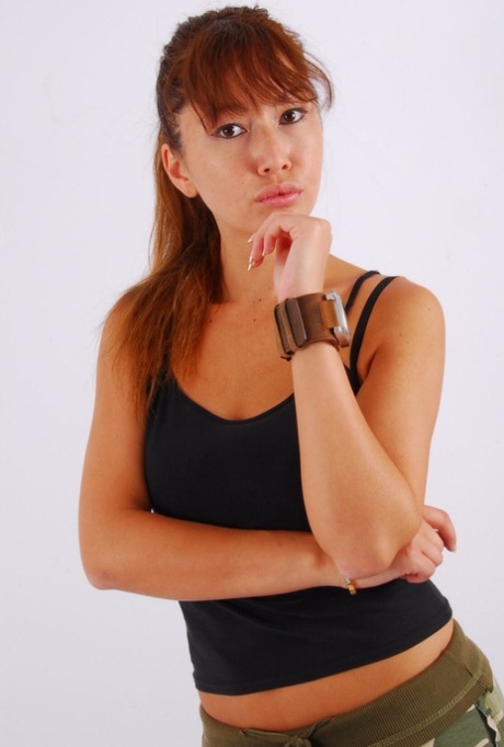 Non-nude action: Asian redhead Evita wears a huge watch with the big OOZOO cuff watch.