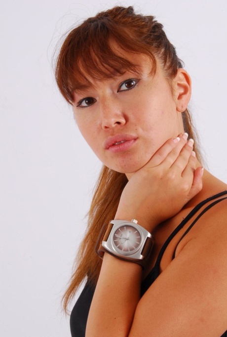 During non-nude action, Evita, an Asian redhead, wears a massive OOZOO cuff watch.