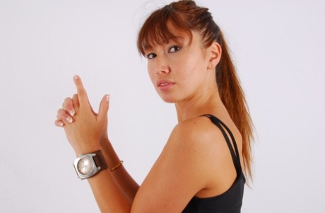 Large OOZOO cuff watch is worn by Asian redhead Evita during non-nude action.