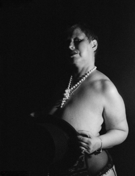 Posh Sophia, a heavy-set adult female, displays her massive breasts in nylons.