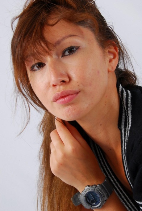 Evita, a red-haired Asian, sports her grey G-Shock watch while fully clothed.