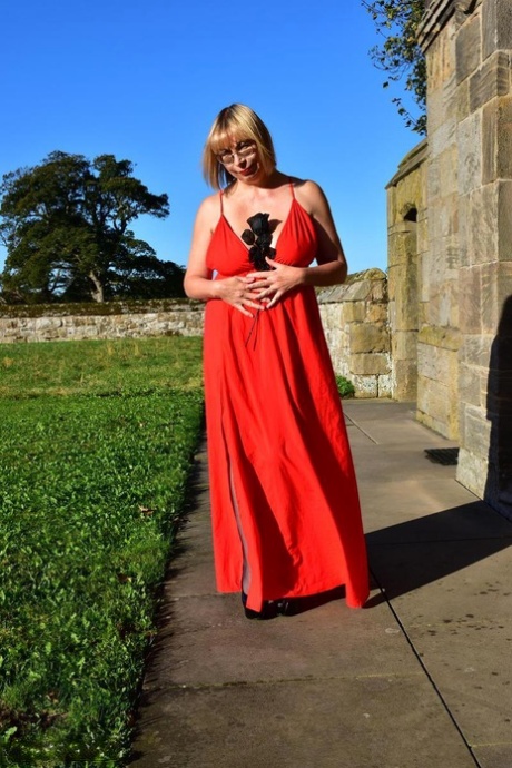 Exquisite: Old blonde Barby Slut dons a red evening dress to be nude in hosiery.