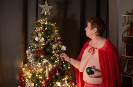 As she grows older, BBW Posh Sophia hangs Christmas ornaments from her tight legs.