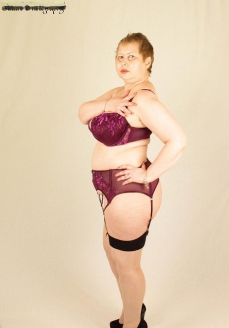 The Posh Sophia, an older plump lady with a plump build, loosens her large breasts from a covering.