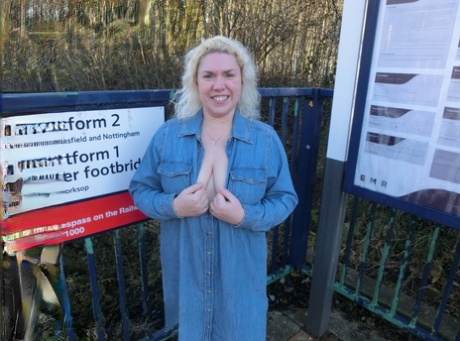 In this train station photo, Barby exposes her tits and pussy while looking older blonde on the platform.