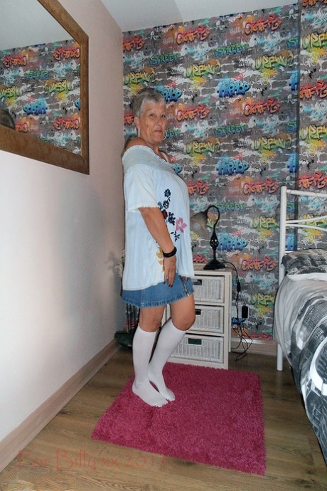 The silver-haired granny Savana sleeps in her bedroom, stripping down to white socks on her knees.