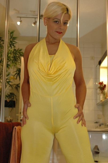 While bathing, Martina removes her yellow jumpsuit as a blonde amateur.