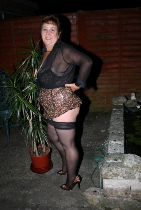 Overweight mature woman Kinky Carol models revealing lingerie in a garden