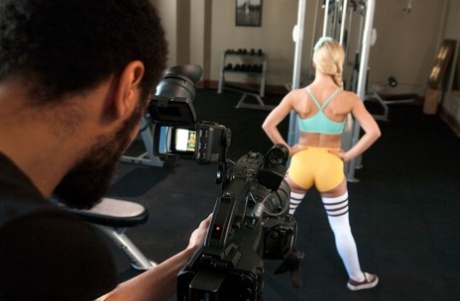The photograph shows a blonde who is athletic being forced into bondage sex by a photographer.