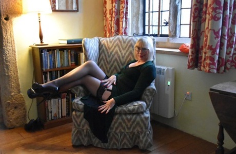When Barby Slut does upskirt action, the older blonde lady displays her vagina on a chair.