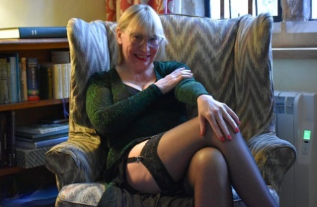 In upskirt action, Barby Slut showcases her vagina on a chair.