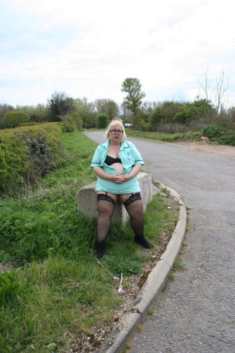 Obese UK woman Lexie Cummings models underthings and nylons beside a road