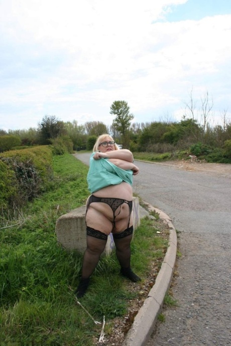 Obese UK woman Lexie Cummings models underthings and nylons beside a road