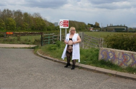 At a roadside location near the body of blonde Lexie Cummings from the UK, she displays her vagina and pussy without clothing.