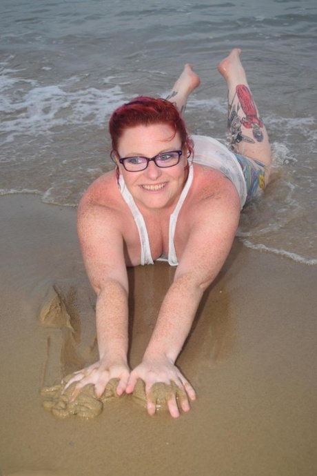 Mollie Foxxx, a young redhead at heart, sweats in the ocean while tattooing her skin.