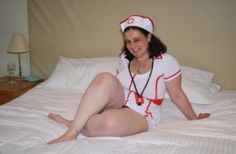 Easily brunette extricates her large breast area and places them on ice on the bed, free from any naughty nurse clothing.