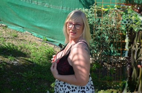 A backyard of mature blonde fatty woman Melody sees her large, bulky breast area on the outside.