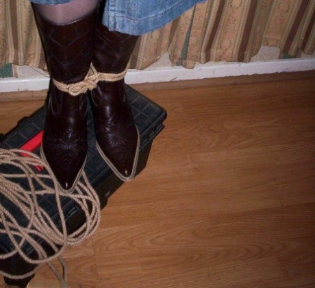 During an evening in a bedroom, an amateur girl exhibits her big pants while being gagged and tied up.