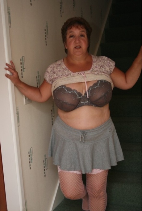 When not performing nude, adult BBW Kinky Carol removes her blouse.