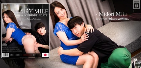 On a bed with her toy boy, Midori Minami, an older Asian woman, engages in sexual activity.