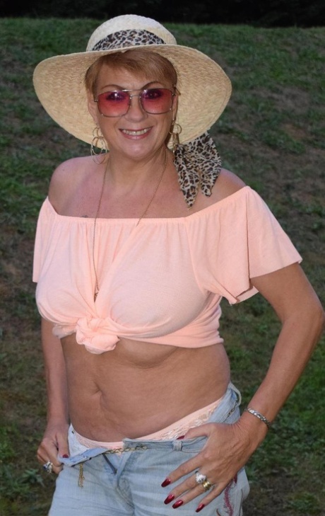 In a backyard, Dimonty's mature female removes her clothes and wears sunglasses.