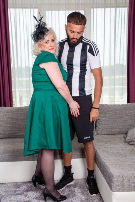 A younger man wears stockings while platinum blonde Pure Vicky has sex.