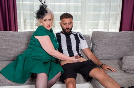 Pure Vicky, the granny with platinum blonde hair, engages in sexual activity while wearing stockings on a younger man.