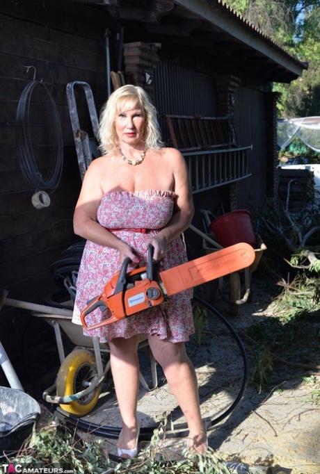 The mature blonde and fat woman Melody uses a chainsaw to control her weight before flaunting her large breasts.