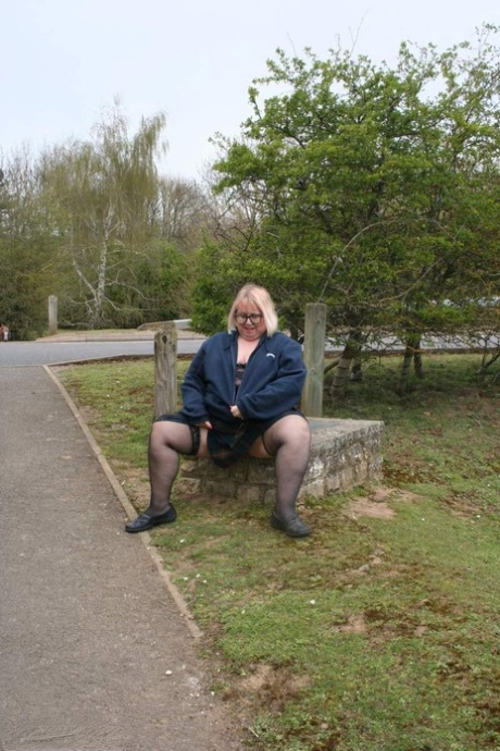 On a concrete block by a road, Lexie Cummings, an Obese UK blonde, pees.