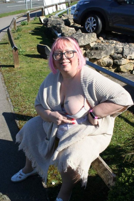 Ex-British Lexie Cummingvis poses in public with her bare breasts and buttocks.