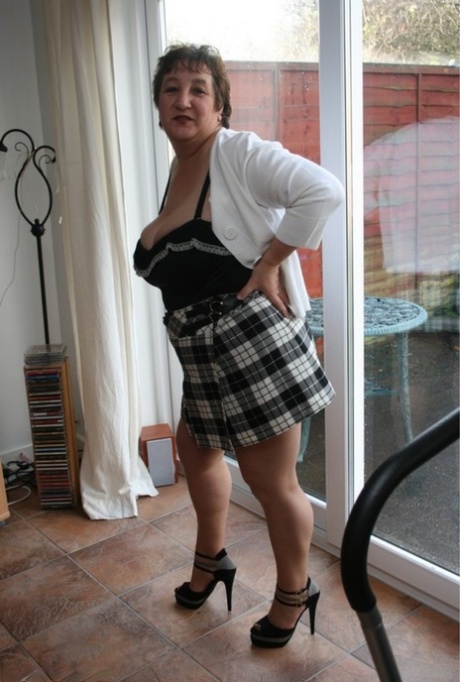 A schoolgirl skirt is taken off by Kinky Carol, an older girl, who is wearing pantyhose.