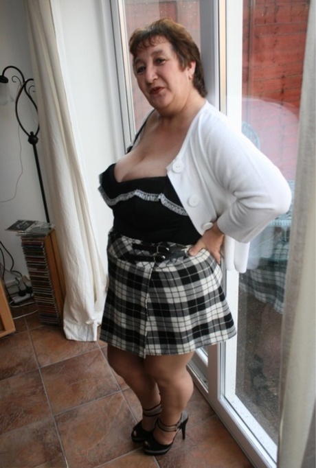Old Kinky Carol, who is a bit more fat than she is here, strips off her schoolgirl skirt while wearing pantyhose.