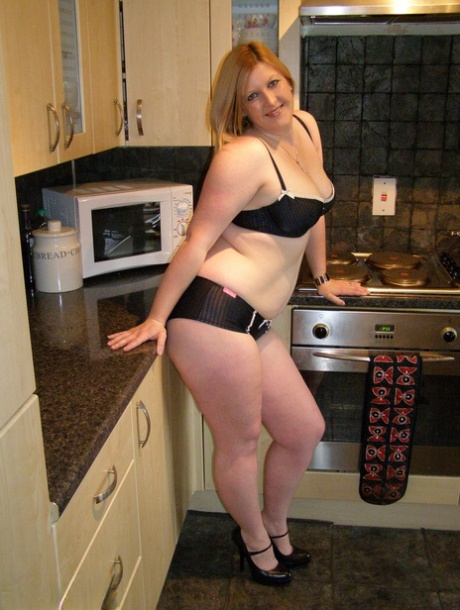 In the kitchen of Samantha, a thin non-professional wears ankle strap heels.