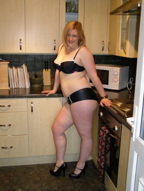 Amanda is a thin woman who wears ankle strap heels in her kitchen.