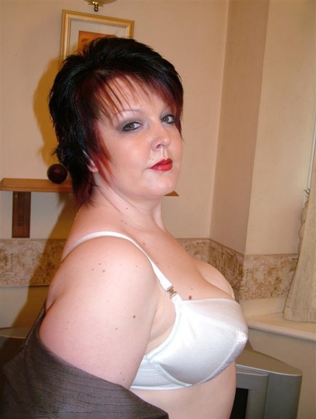 British woman Double Dee, who is overweight and has a fit of brown hair, wears nylons covering her back seams to up her skirt.
