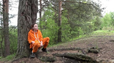 Европейская девушка писает на землю в лесу