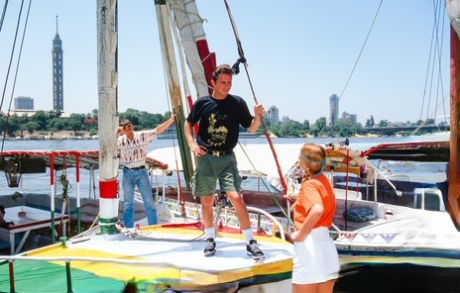 Nikky Andersson and Julia engage in sexual activities with a group of sailing enthusiasts during foursome sex.