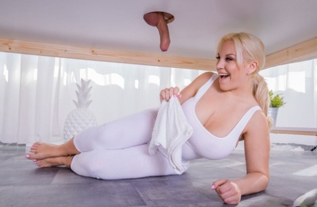 Blondie Fesser, the curvy blonde masseuse, dries her penis while sitting on a milking table.