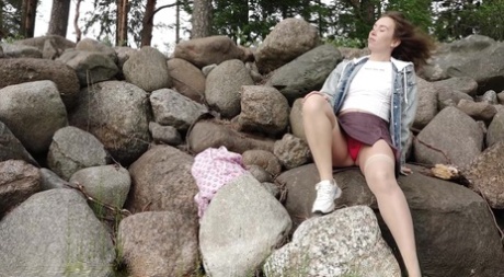 Brunette Babe Pees Over The Rocks Outside