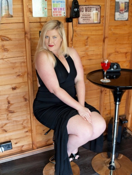 Samantha, a blonde BBW, displays her prominent buttocks while wearing black heels and going nude.