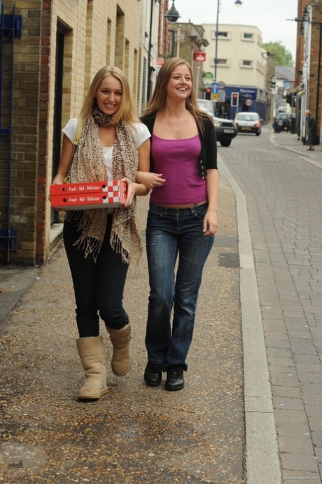 Pizza: Hayley Marie Coppin and Nikki F strip to their looks while eating pizza.