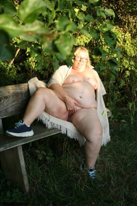 In the rural area, Lexie Cummings (an obese British woman) plays with her dick in hand.