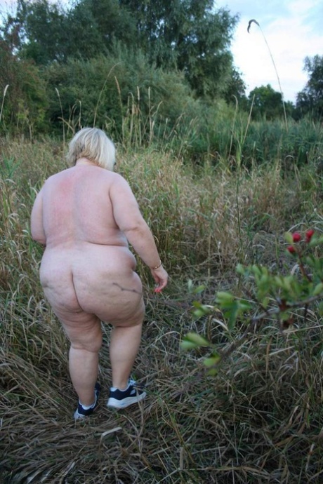 Lexie Cummings, a fat British woman, is seen stripping in the country.