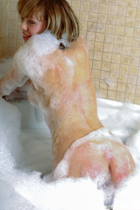 While taking a bubble bath, the young beauty Karen A showcases her impressive physique.