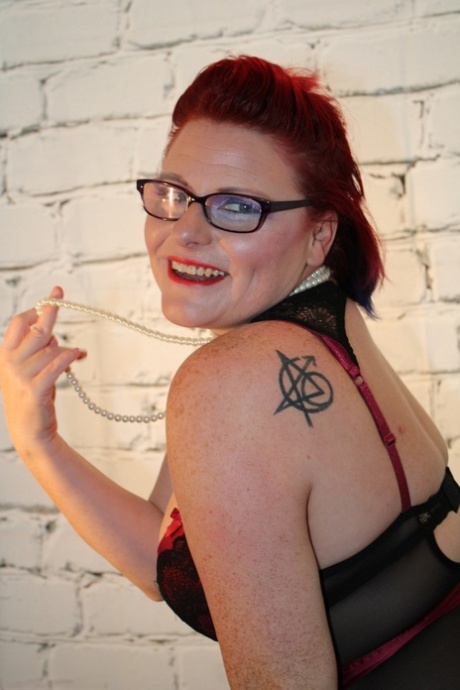 Chubby redhead loses her tits while wearing glasses and nylons.