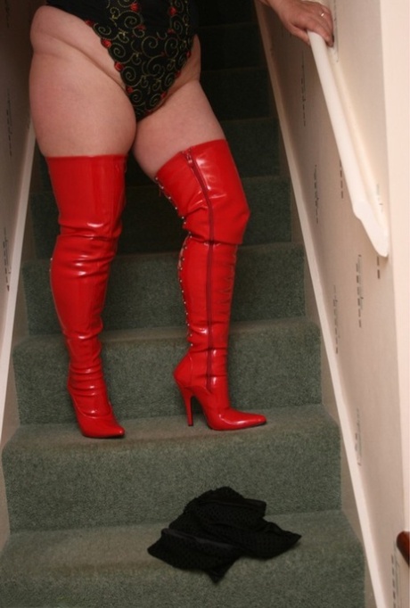 Mature fatty Kinky Carol shows her big tits and snatch in thigh-high boots