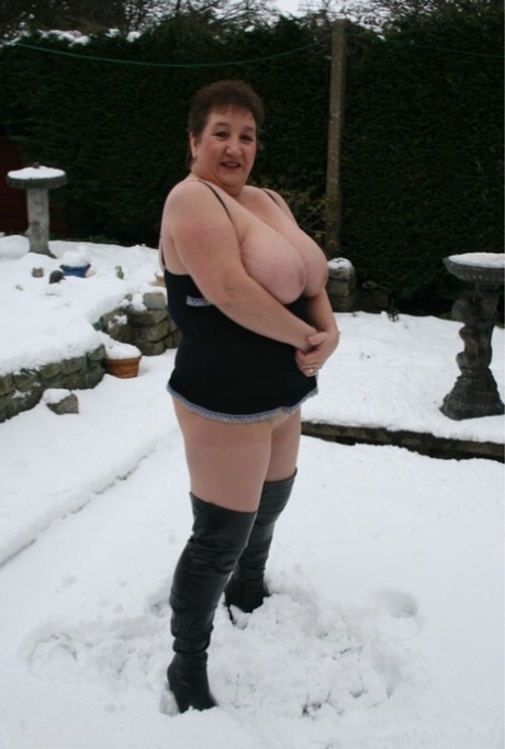 While making snowballs, Kinky Carol from the UK exposes her oversized chest and buttocks.